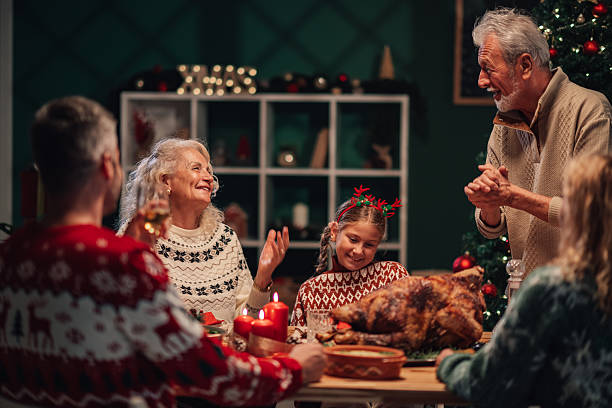 istock Family celebrating christmas dinner with roasted turkey 2235125302