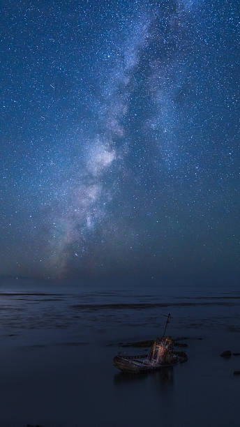 istock The milky way over broken boat 2235126595