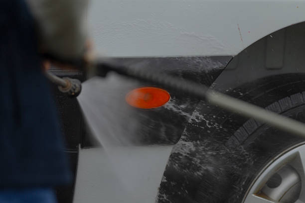 istock A person is using a high pressure washer to clean a cars surface thoroughly 2235128050
