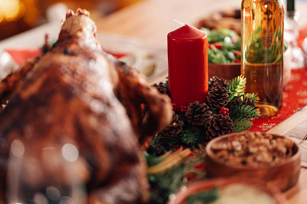 istock Christmas dinner table setting with roasted turkey and festive decorations 2235128386