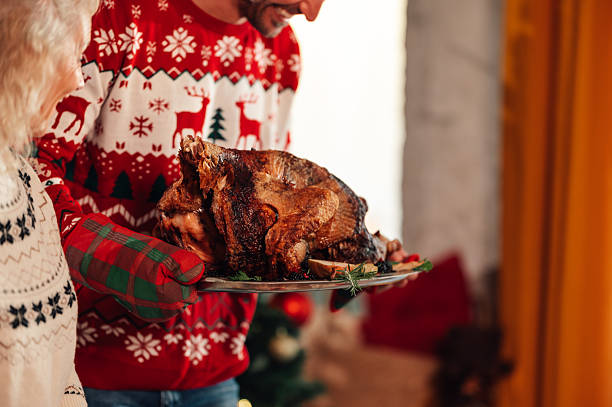istock Family bringing roasted turkey for christmas dinner celebration 2235128408
