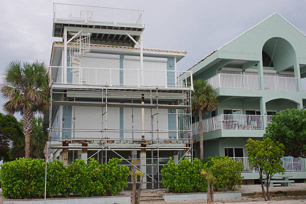 Scaffolding on a Coastal Home Under Renovation Near Palm Trees