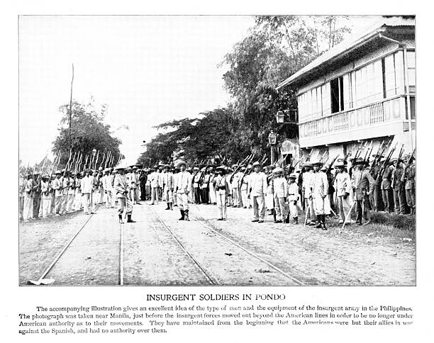 Spanish-American War, Filipino Insurgent soldiers in Pondo, near Manila, Luzon Island, Philippine Islands, an archipelago in the Pacific Ocean.  Photograph engraving published 1898. Copyright expired; artwork is in Public Domain.