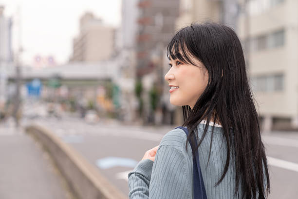 istock attractive asian woman going out 2235132902
