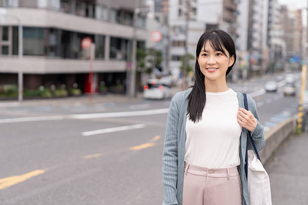 istock attractive asian woman going out 2235132911
