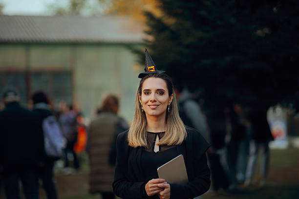 istock Smiling Halloween Party Event Organizer Holding a Tablet 2235138704