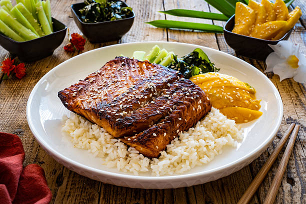 istock Seared teriyaki salmon steak with white rice on wooden table 2235140921