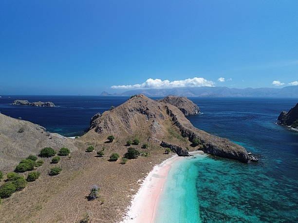 istock a hill, turquoise sea and a pink beach 2235143593
