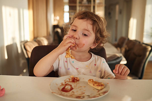 istock Beautiful girl eating in the kitchen 2235143620