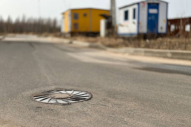 istock A iron hatch with a pattern above an observation well is located on auto road in daytime 2235143661