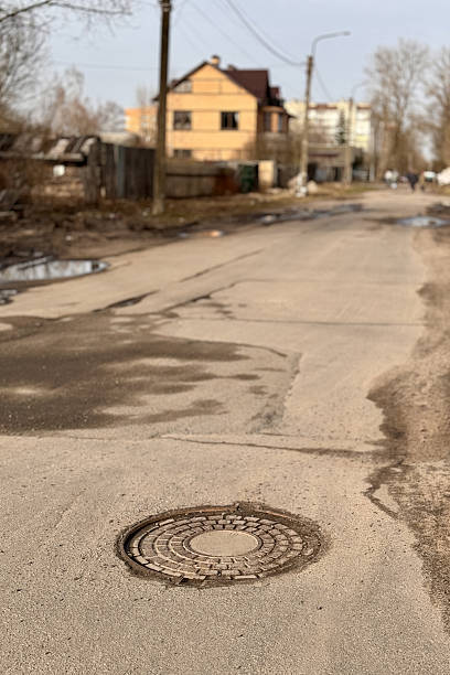 istock A old iron hatch with a pattern above an observation well is located on auto road in daytime 2235143982