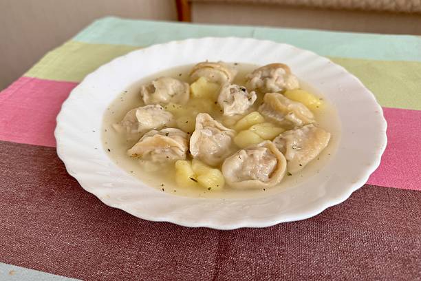istock Delicious home dumplings from a white plate from a table in a restaurant 2235146066