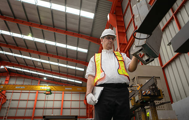 istock Senior experienced technician checking large machine on a production line 2235150790