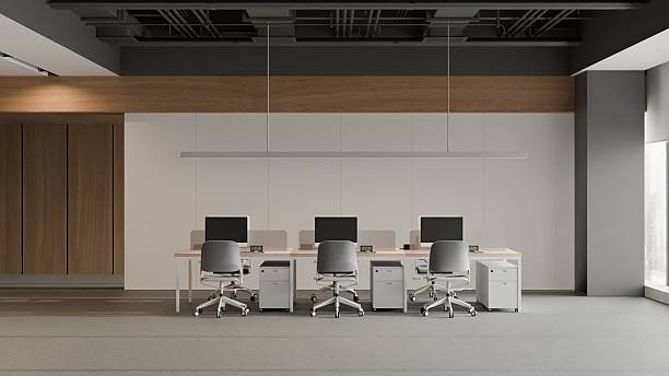 istock Modern open-plan office interior with rows of empty workstations and contemporary wood paneling. 2235153020