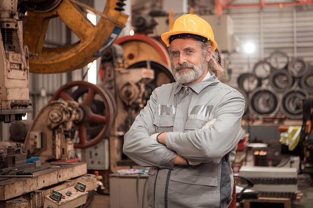 istock Senior experienced technician checking and maintenance a large machine in metal sheet factory 2235153371