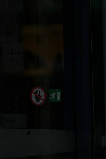 istock Emergency Exit and No Entry Signs Displayed on the Glass Door 2235155540