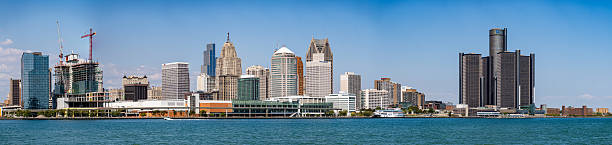 Aerial shot of the Detroit River flowing between Detroit, Michigan and Windsor, Ontario from over Belle Isle, with the sun setting behind the Detroit skyline. This still image is part of a series; a time lapse video is also available.