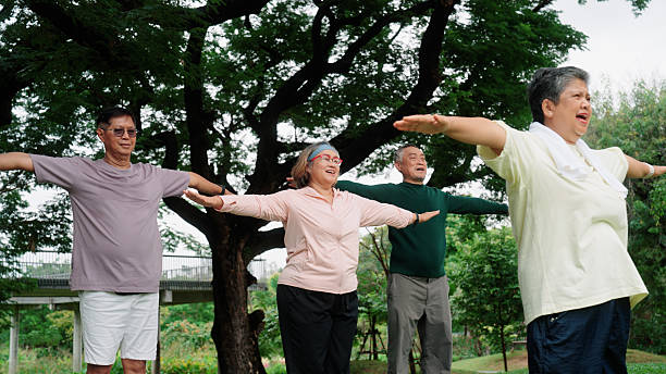 istock Senior group performing yoga exercises outdoors in a public park 2235158339