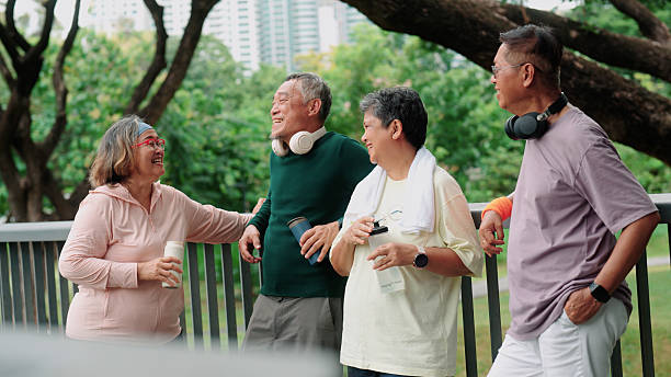 istock Active elderly people resting, smiling, and chatting together in the park 2235158350