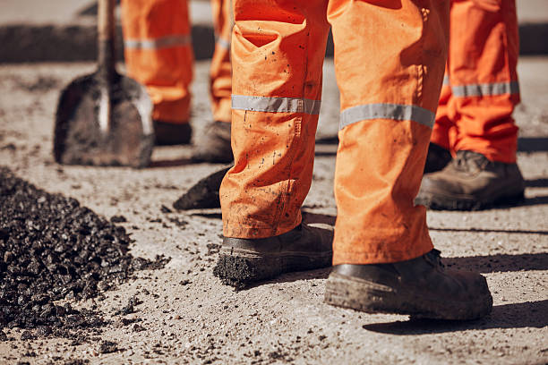 istock Construction workers working on a new asphalt layer on a public street. 2235159465