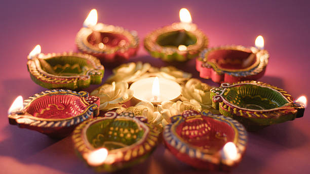 istock lighting candles for Diwali celebration 2235162767