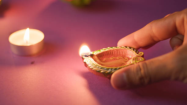 istock Closeup of hand holding lit candle 2235162787