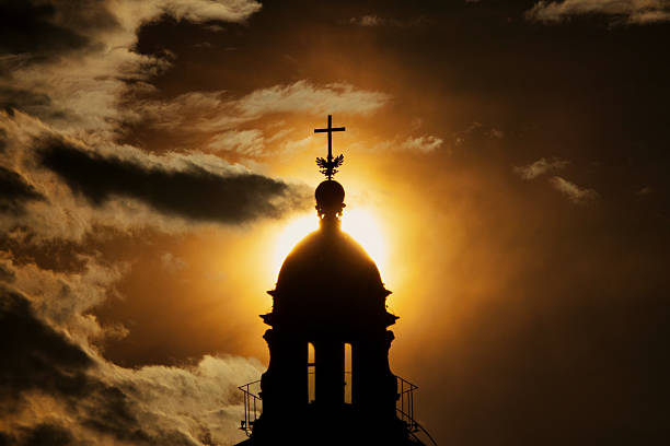 Silhouette of the lanterna of Santa Maria Maggiore in Rome, Italy, with the sun directly behind it.