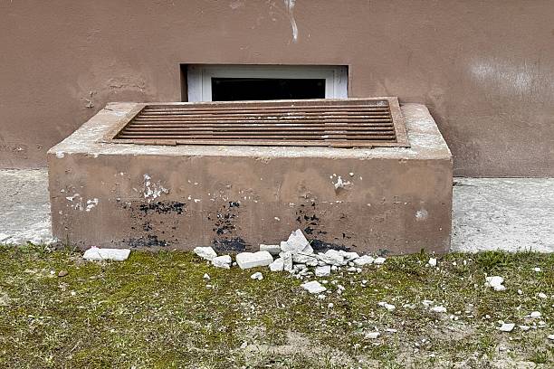 Basement opens in the building of house has window is located below ground level. The window is covered with a lattice of steel rods to protect any entry into the basement