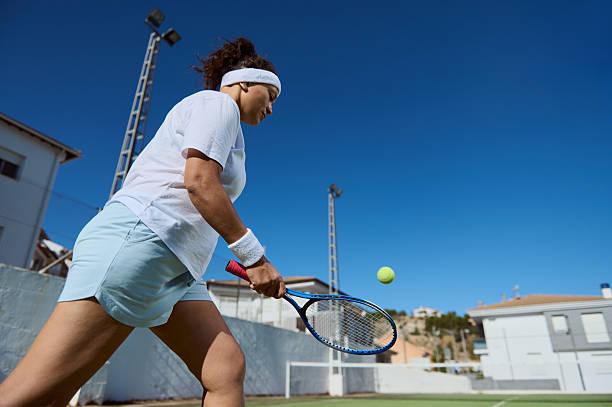istock Woman Playing Tennis Outdoors on a Clear Sunny Day 2235167375