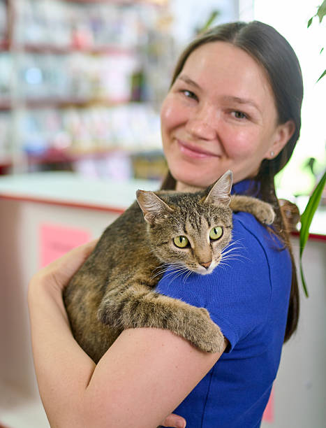 istock Attractive Young Woman With Her Tabby Cat In Veterinary 2235167434