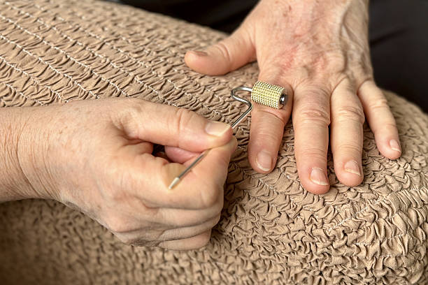 istock An unknown elderly woman makes herself a hand massage with her hand with a massager in the form of a needle-shaped silver roller 2235170212