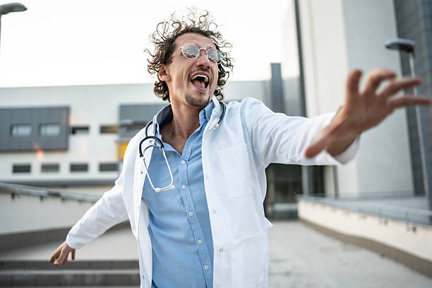 istock Energetic Doctor with Stethoscope Expressing Excitement Outdoors Near Modern Building 2235174105