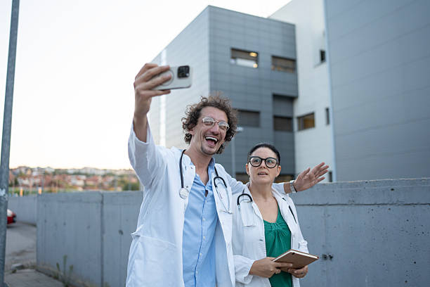 istock Two Medical Professionals Taking a Selfie Outdoors with Joyful Expressions 2235174152