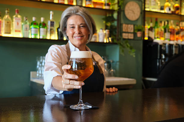 istock Bartender serving glass of beer in pub 2235174840