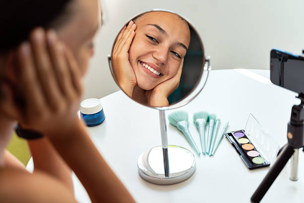 Happy Girl Admiring Herself in Makeup Mirror