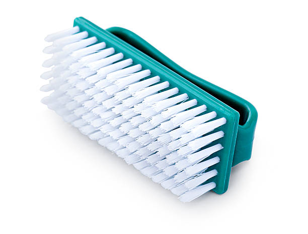 Plastic cleaning brush with white bristles and turquoise handle, lying on a white background