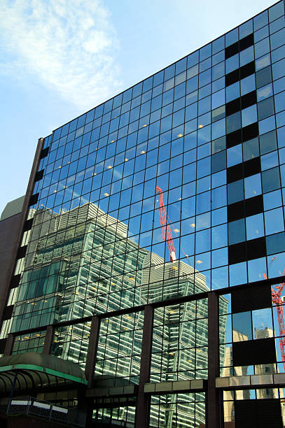 Reflection of a construction site office block skyscraper in glass windows at Birmingham England,  architecture stock photo image
