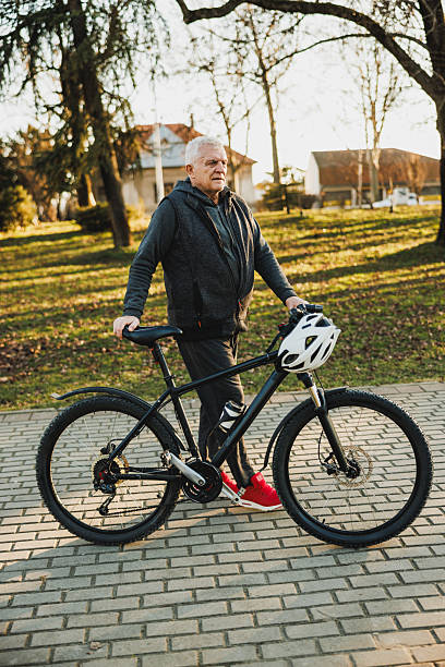 istock Man Walking a Bike Down a Sidewalk 2235180616