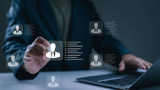 istock Human resources manager using futuristic digital interface recruitment hiring. Businessman hand selects candidate profile on virtual screen, evaluating their resume corporate employment talent 2235182081
