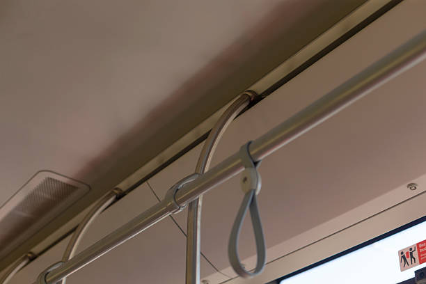 This is a detailed closeup view of a hand rail found on a bus, showcasing the intricate design and sturdy construction of the metal