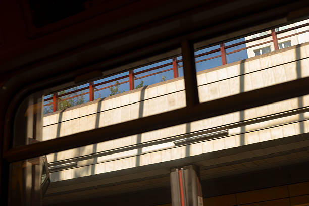 A beautifully designed window equipped with a railing features a stunning blue sky that perfectly complements its aesthetic appeal