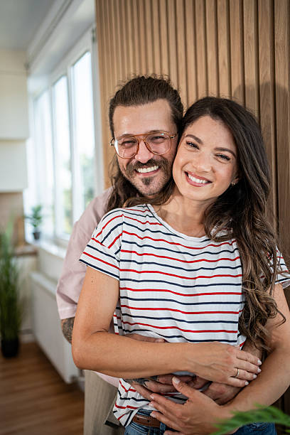 istock Happy smiling couple embracing at home, showing love and affection 2235187982