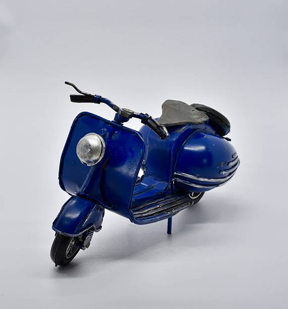 istock lovely tiny blue motorcycle toy on white backgroundp 2235188120