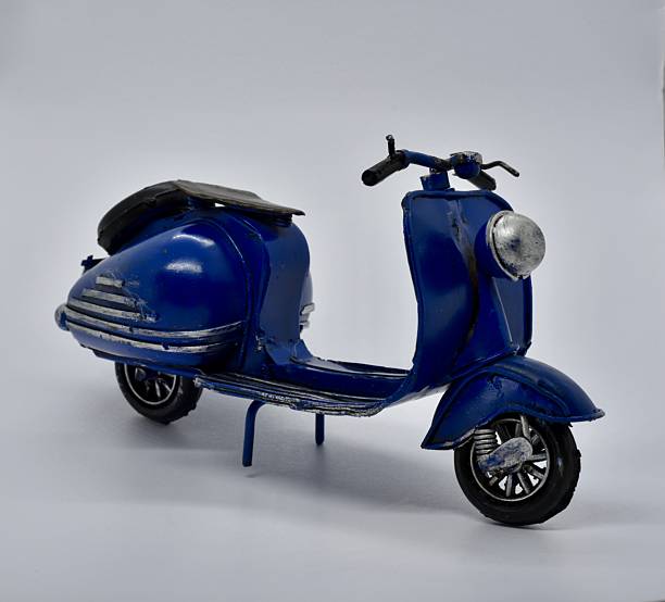 istock lovely tiny blue motorcycle toy on white backgroundp 2235188170