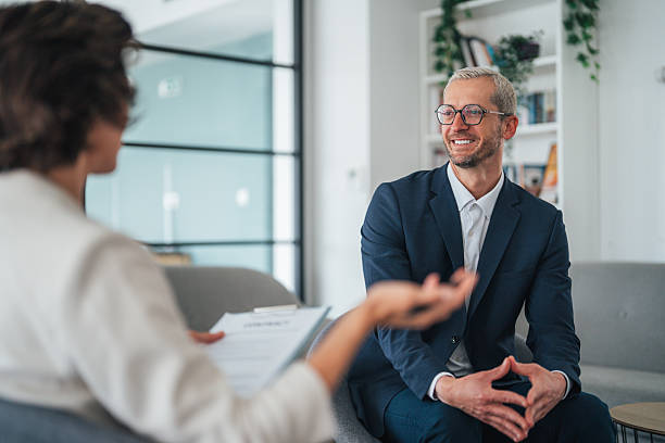 istock Collaborative discussion in a modern office. Happy businessman smiling while discussing sales with his colleague. 2235188225