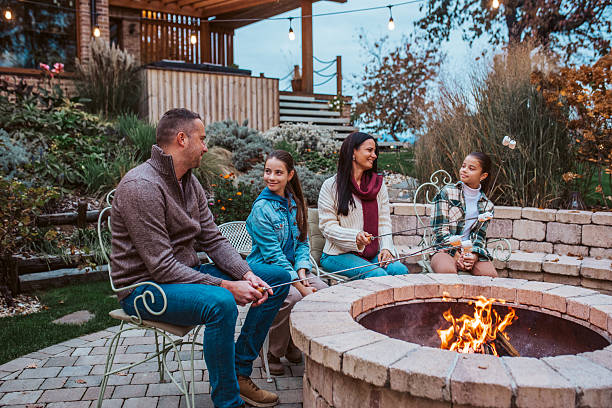 istock Family roasting marshmallows over open flame, campfire on backyard. 2235188440