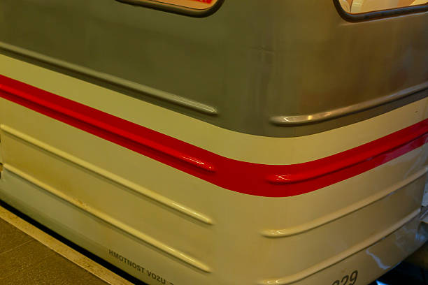 A gray and white train adorned with a striking red stripe running along the side, creating a beautiful contrast and a unique look