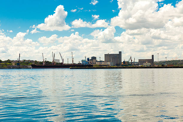 A row of silos reflected in the waters of the harbour in Aarhus, a port city in eastern Jutland, mainland Denmark.