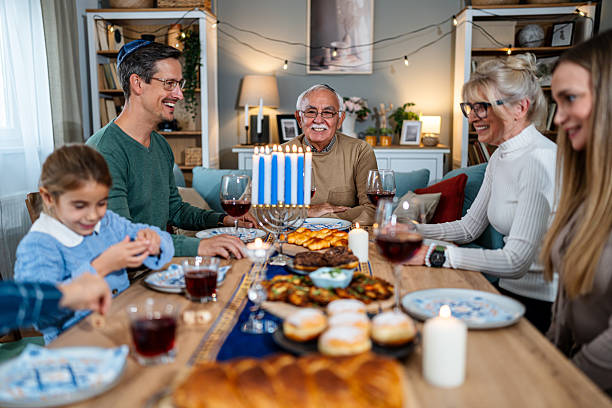 istock Extended family celebrating Hanukkah with festive dinner 2235194046