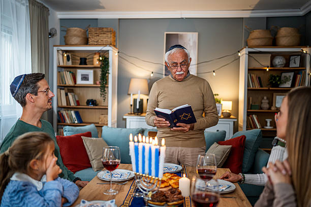 istock Extended family celebrating Hanukkah with traditional dinner and prayers 2235194322